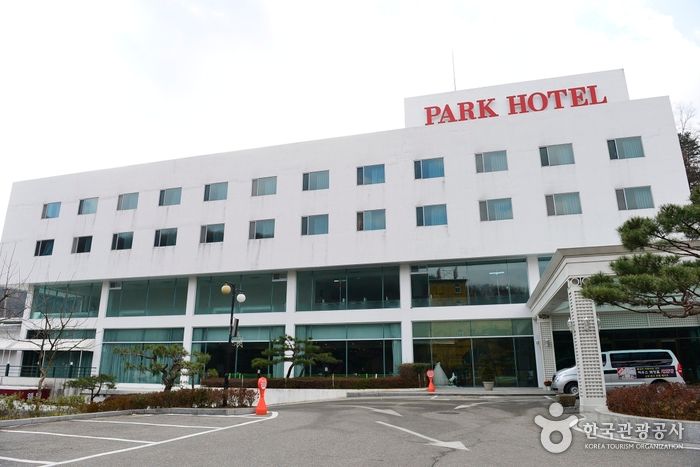 Exterior of Gimcheon Park Tourist Hotel, a white four-story building with a PARK HOTEL sign, and its parking lot