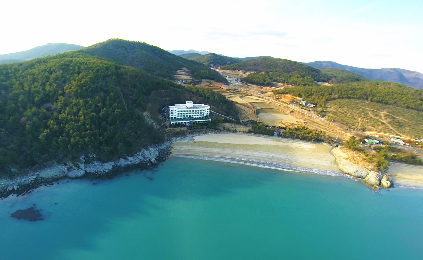 Aerial view of Victoria Hotel on a wooded hill above Balpo Beach in Goheung